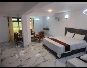 a hotel room with a bed and a desk at Hotel shree ji in Lucknow