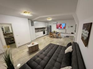 a large living room with a couch and a table at Casa Florescu in Craiova