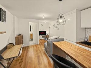 a kitchen and living room with a couch and a table at Le Refuge in Valence