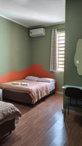 a bedroom with a bed and a window and a chair at Hotel Real Paulista in São Paulo +121 photos