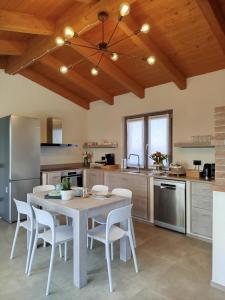 a kitchen with a table and chairs in a room at Il Giardino di Sofia B&B in Piozzo