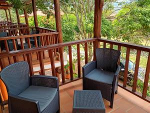 a porch with two chairs and a table at HotelQuintaMaria in Barichara +6 photos
