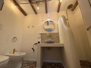 a bathroom with a sink and a toilet at Bella Gallery Terrasini in Terrasini +52 photos