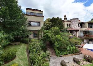 an exterior view of a house with a garden at Maja Hotel Boutique in Morelia