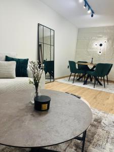 a living room with a table and a couch at martIN Apartment 2 in Bansko