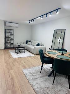 a living room with a table and a couch at martIN Apartment 2 in Bansko