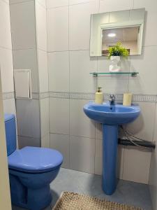 a bathroom with a blue sink and a toilet at martIN Apartment 2 in Bansko