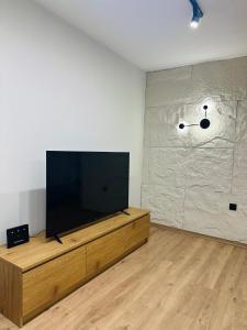 a living room with a flat screen tv on a wooden entertainment center at martIN Apartment 2 in Bansko