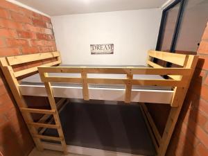 a bunk bed in a room with a brick wall at Casa Roma - La tranquilidad del campo en la Ciudad - RNT 1 0 8 1 3 7- in Salento