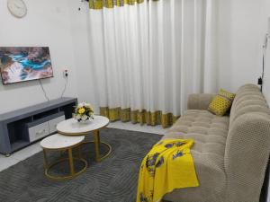 a living room with a couch and a table at Jojos Serenity Stay in Bamburi