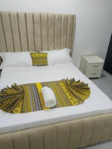 a large bed with a blanket on it at Jojos Serenity Stay in Bamburi