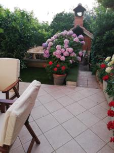 a patio with pink and purple flowers in a garden at Apartment Pavin in Poljana