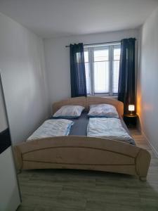 two twin beds in a room with a window at Weserblick Apartment Stolzenau 24h Selfcheckin in Stolzenau