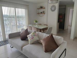 a living room with a couch and a dining table at Playa dorodo in La Chorrera