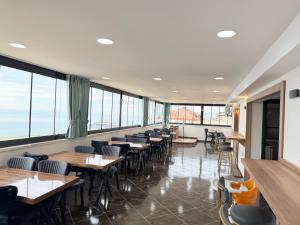 a restaurant with tables and chairs and large windows at Sulduz Hotel Apart & SPA in Trabzon