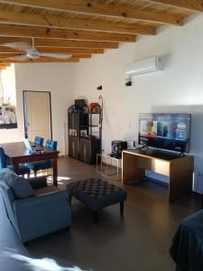 a living room with a couch and a tv at Loft Moderno in Viedma