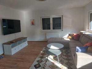 a living room with a couch and a tv at Apartment King in Travnik