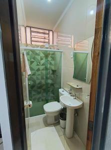 a bathroom with a toilet and a sink and a shower at Hotel Graunas in São Carlos +36 photos