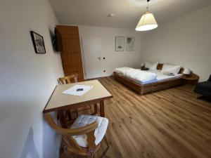 a room with a bed and a table with a desk at Bergauszeit mit Sauna in Aschau im Chiemgau