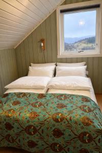 two beds in a room with a window at The Nordic Loft in Bergen