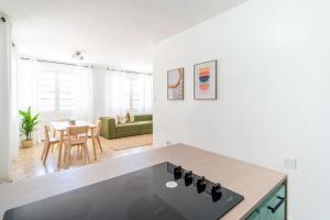 a kitchen with a counter top and a living room at Comfortable & Spacious Mountain Home in Utuado in Cayuco