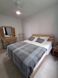 a bedroom with a large bed and a mirror at L'écrin de Saint-pierre - Sunset & Sea View in Saint-Pierre