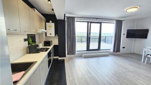 a large kitchen with a large window with a view at Copou Luxury Suites in Vaslui