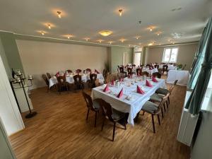 a large room with tables and chairs in it at Hotel LEANO in Lübeck