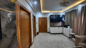 a room with a kitchen and a hallway at 2 BHK Starry Night Penthouse in Islamabad +6 photos