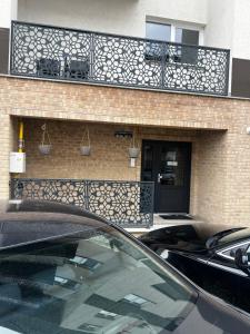 a car parked in front of a building with a balcony at Dny Luxury in Rădăuţi