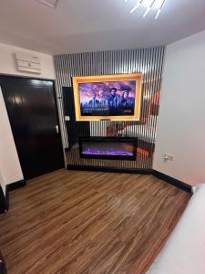a living room with a painting on the wall at Luxury Jacuzzi Suites Halifax in Halifax