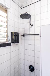 a bathroom with a shower with white tiles at Comfortable & Spacious Mountain Home in Utuado in Cayuco +37 photos
