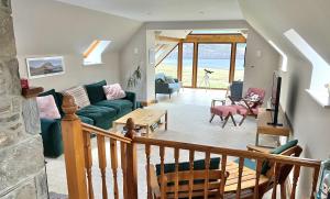 a living room with a couch and a table at Morenish Estate in Killin