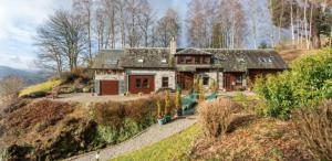 a house sitting on top of a hill at Morenish Estate in Killin