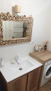 a bathroom with a sink and a washing machine at Apartament na Bora in Tarnów