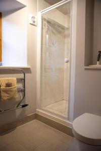 a shower with a glass door in a bathroom at Morenish Estate in Killin +39 photos