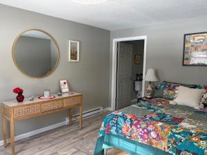 a bedroom with a bed and a mirror on the wall at Crawford Suite in Meadville
