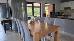 a wooden table and chairs in a kitchen at AVillaT15SelborneGolfEstatePennington in Pennington