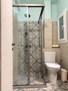 a bathroom with a shower and a toilet at Anefos apartment in Ágios Rókkos