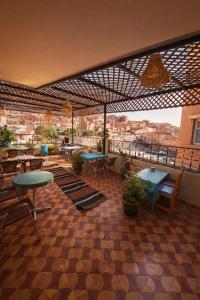 a restaurant with tables and chairs and a view of a city at Hôtel Restaurant BOUGAFER in Boumalne Dades