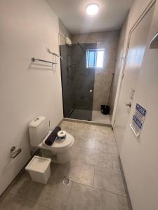 a bathroom with a toilet and a shower at Downtown apartments in Kralendijk