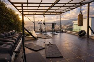 a gym with a view of the mountains at Glass Mansion Breathtaking 180 Panoramic View in Envigado +31 photos