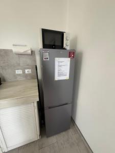 a refrigerator with a microwave on top of it at Downtown apartments in Kralendijk