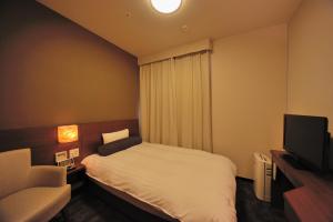 Tempat tidur dalam kamar di Dormy Inn Premium Shibuya-jingumae