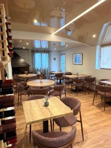 a restaurant with tables and chairs and a piano at les chambres d'hotes du chalet in Venaco