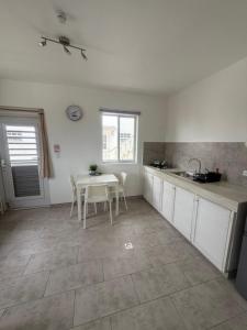 a kitchen with a table and a table and a sink at Downtown apartments in Kralendijk