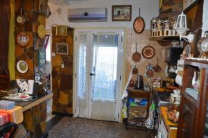 a kitchen with a door in a room withcellaneous items at Mostaganem kharrouba apartment f3 in Mostaganem +9 photos