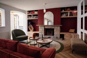 a living room with a couch and a fireplace at B&B Villa Marie-Lou in Le Portel