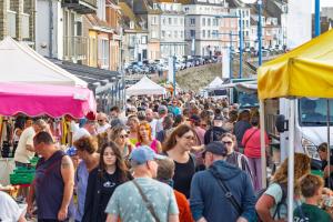 a crowd of people walking through a crowded market at B&B Villa Marie-Lou in Le Portel