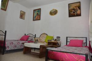 a living room with two beds and a table at Mostaganem kharrouba apartment f3 in Mostaganem